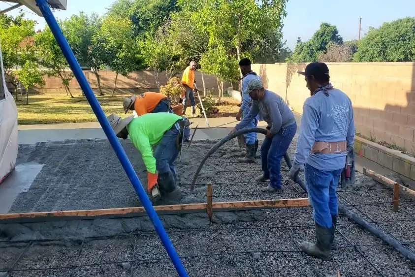 The Monroe Masonry crew screeding a fresh concrete pour